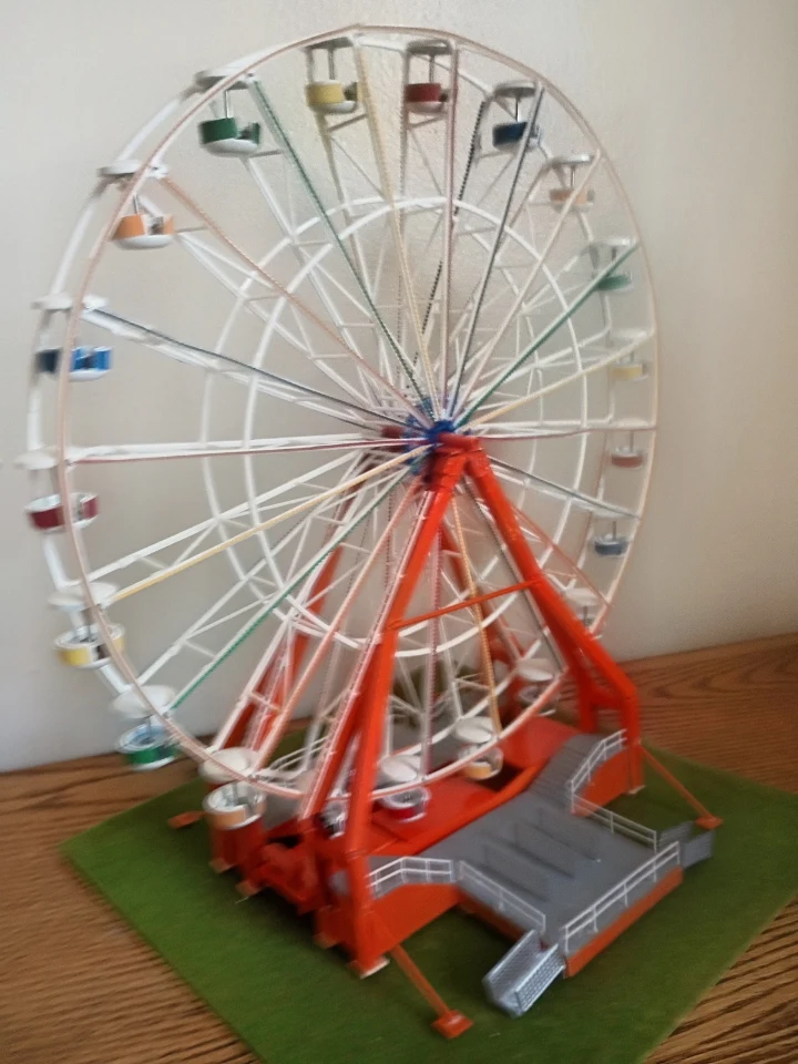 Handcrafted HO scale Chance Giant Wheel with colorful gondolas on a green base